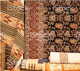 A variety of rugs on display in a store.