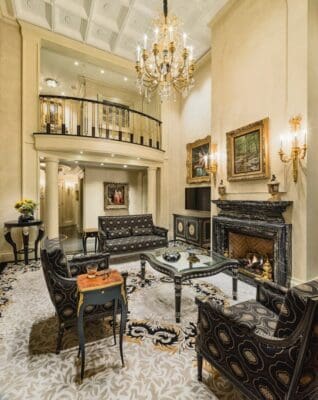 A living room with two floors and a fireplace.