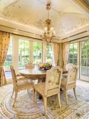 A dining room with a table and chairs in it