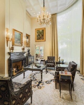 A living room with a fireplace and two chairs