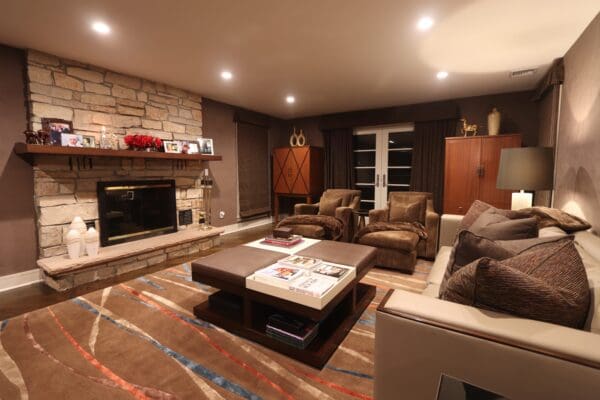 A living room with couches, chairs and a fireplace.