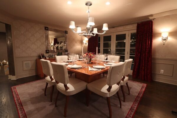 A large dining room table with white chairs.